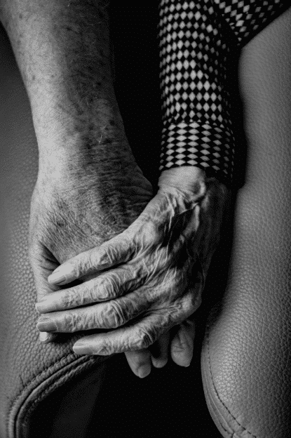 Two old people holding hands in a Halifax, Nova Scotia nursing home.